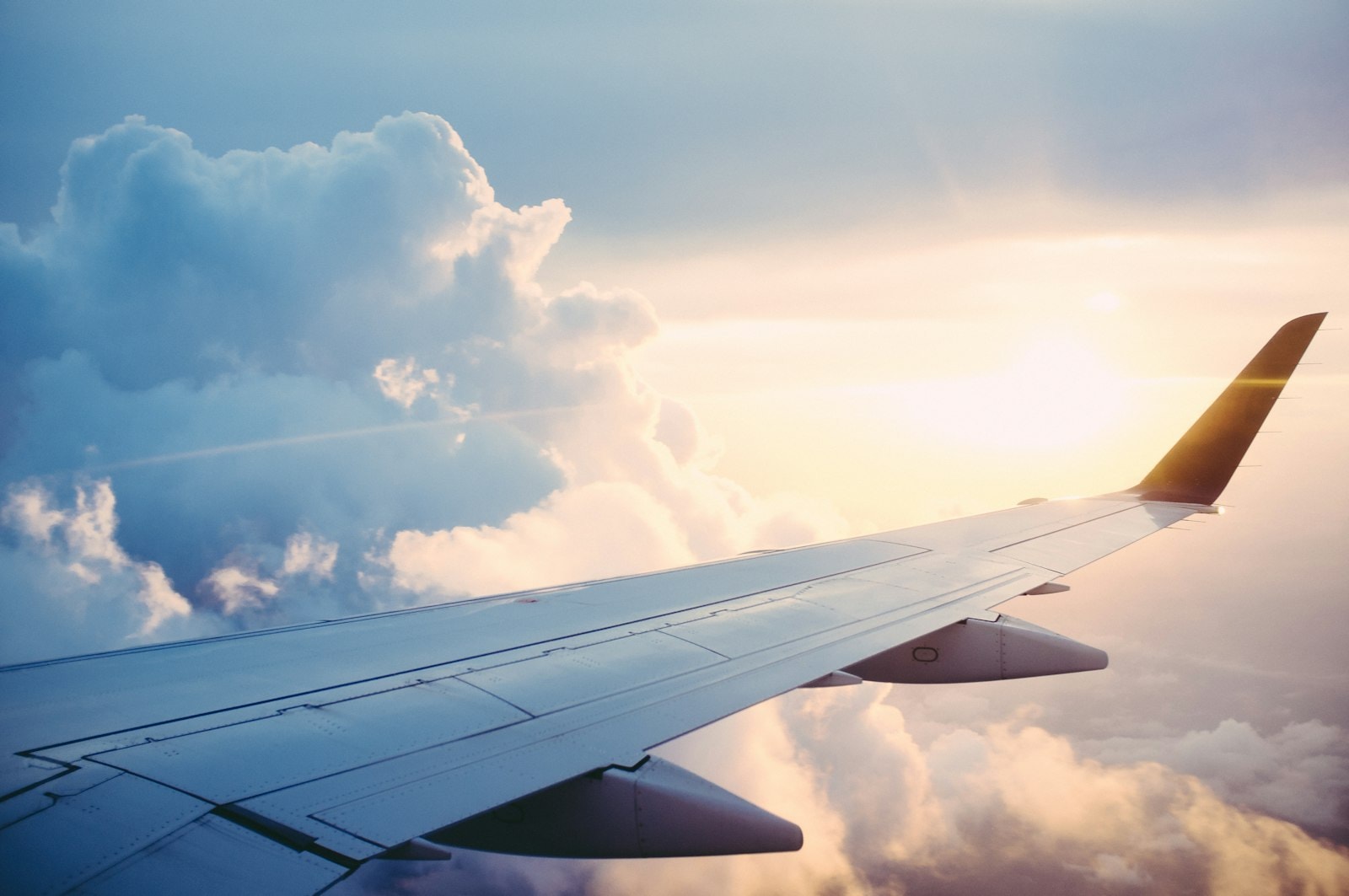Commercial airplane flying above clouds